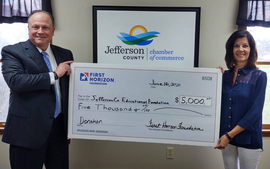 Tim Coley with First Horizon and Donna Yates with Chamber of Commerce holidng a check for 5,000 dollars which was donated by First Horizon Foundation to Jefferson County Education and Community Foundation
