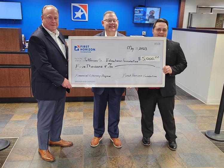 Jefferson County Chamber of Commerce President with First Horizon bank branch presidents holding large check for Jefferson County Educational Foundation